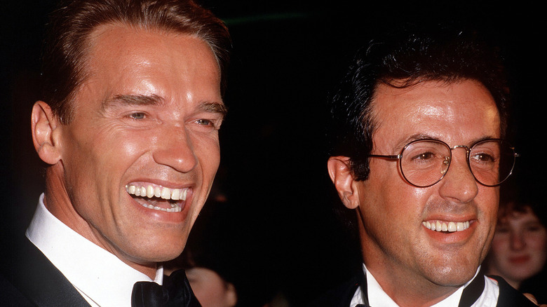 Arnold Schwarzenegger and Sylvester Stallone smiling