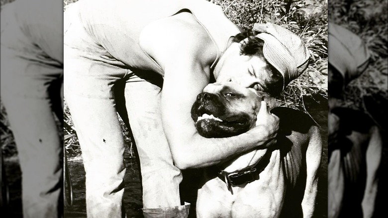 Sylvester Stallone hugging his dog in the early 1970s