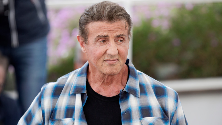 Sylvester Stallone looking somber off camera