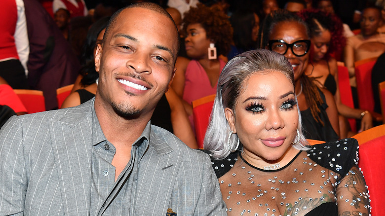 T.I. and wife Tameka "Tiny" Harris sitting in an audience