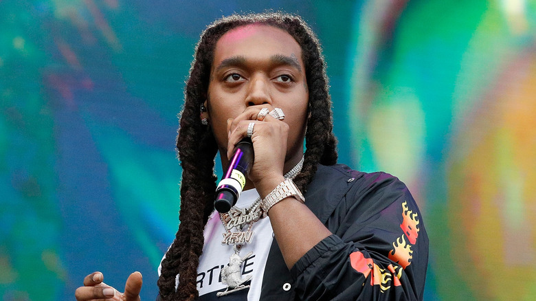 Takeoff performing at a concert 