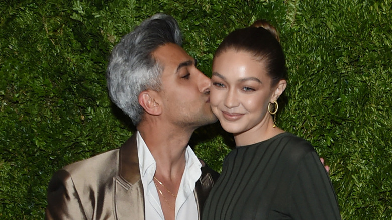 Tan France kissing Gigi Hadid