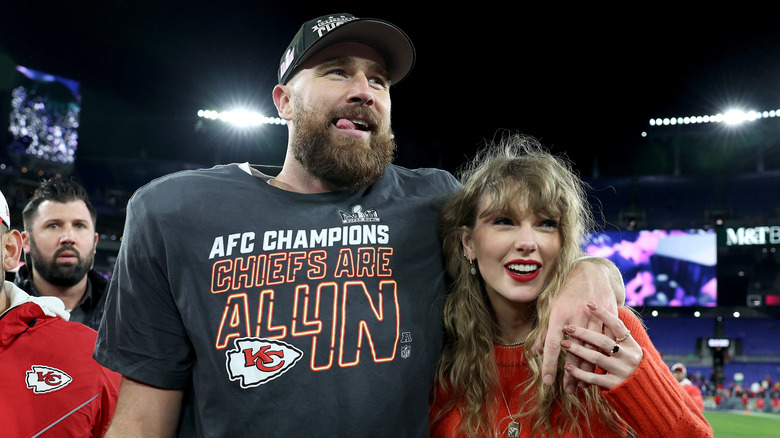 Travis Kelce with arm around Taylor Swift