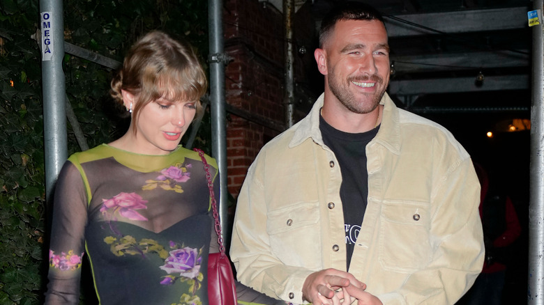 Taylor Swift and Travis Kelce holding hands