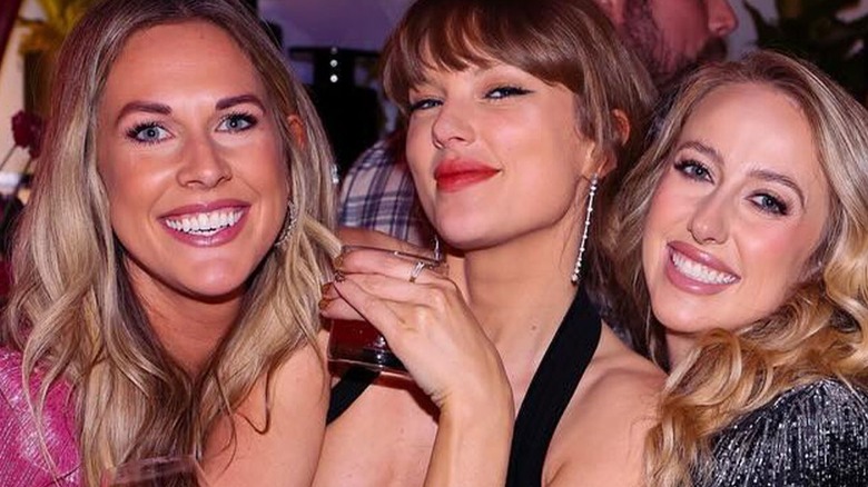 Lyndsay Bell, Taylor Swift, and Brittany Mahomes posing at Eras Tour wrap party