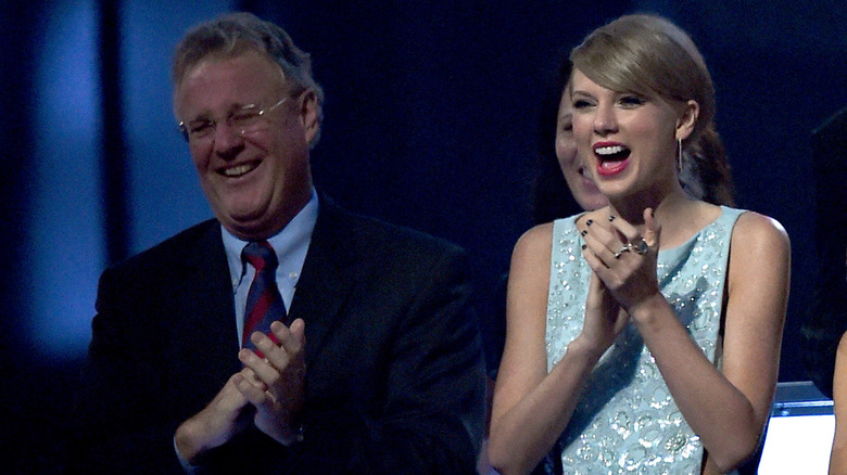 Scott Swift and Taylor Swift clapping hands