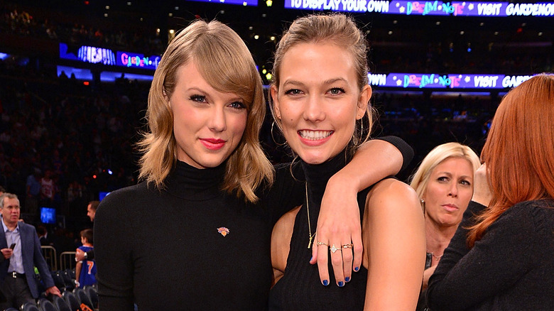 Taylor Swift with arm around Karlie Kloss