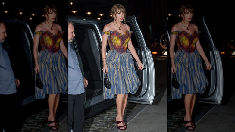 Taylor Swift exiting a car in a multicolored Vivienne Westwood dress