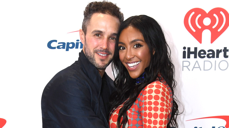 Zac Clark and Tayshia Adams hugging on red carpet