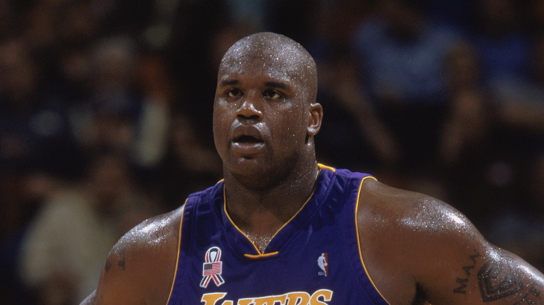 Shaquille O'Neal standing and looking sweaty 