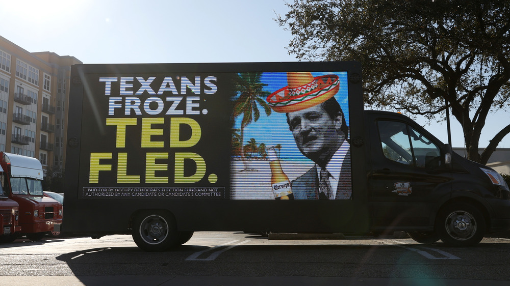 A truck with a message and image mocking Ted Cruz after leaving Texas amid the winter storms