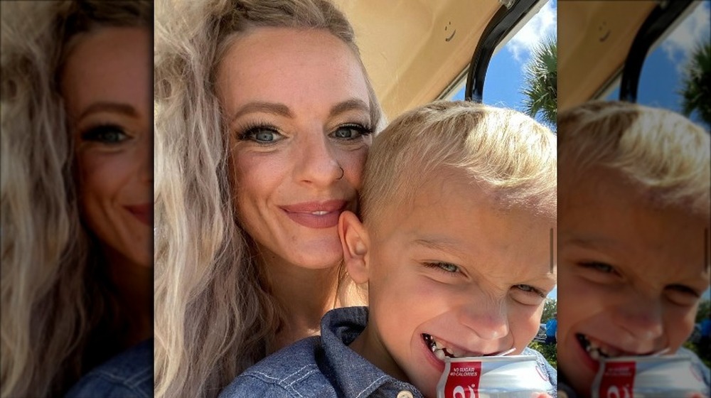 Mackenzie McKee taking selfie with her son holding a Coke can