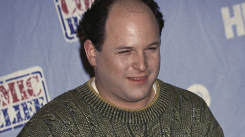 Jason Alexander smiling, knitted sweater