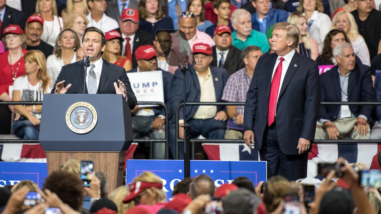 Ron DeSantis speaking with Donald Trump nearby