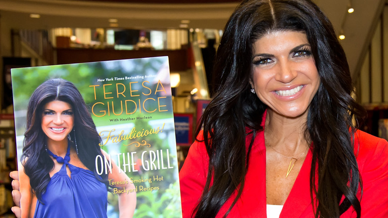 Teresa Giudice posing with cookbook