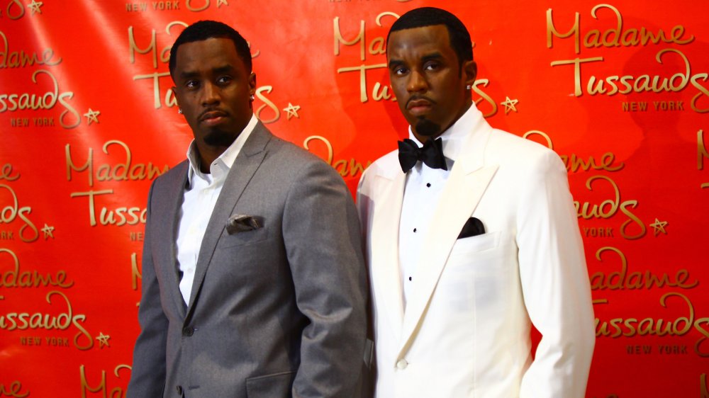 P. Diddy posing with his wax figure 