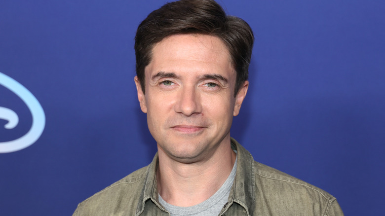 Topher Grace smiling at event