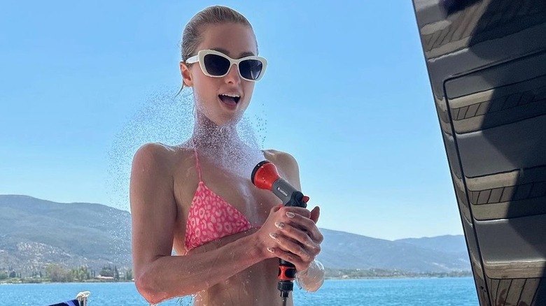 Paris Hilton spraying herself with water