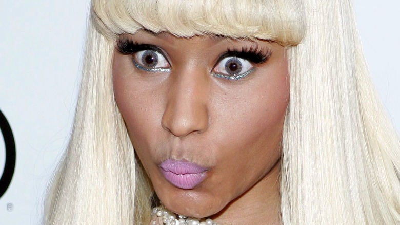 Nicki Minaj looking shocked in platinum blonde wig