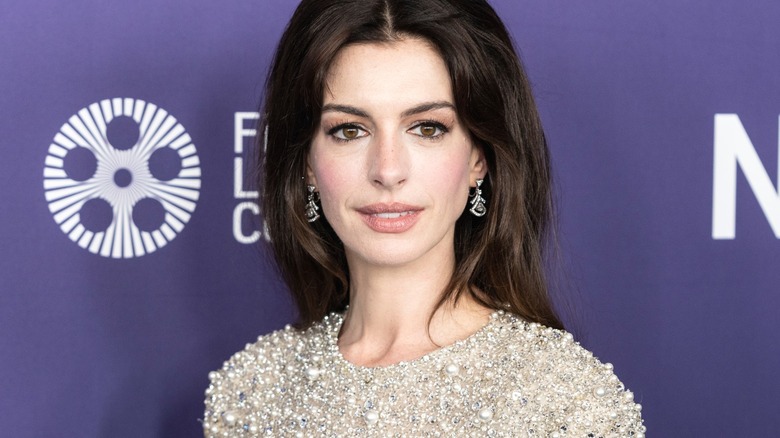 Anne Hathaway purple backdrop