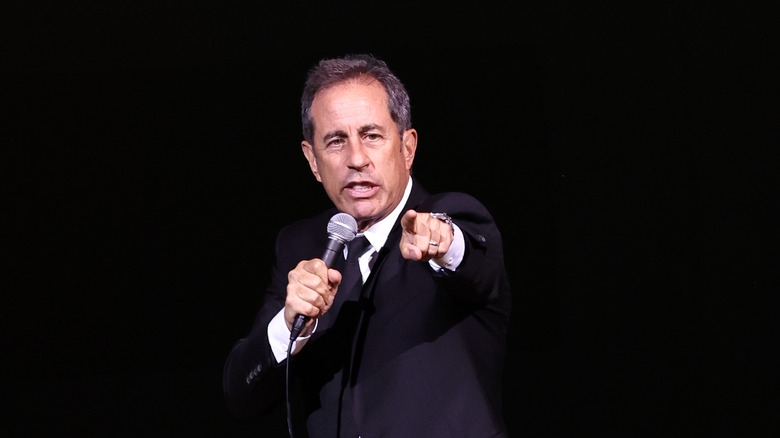 Jerry Seinfeld holding a mic