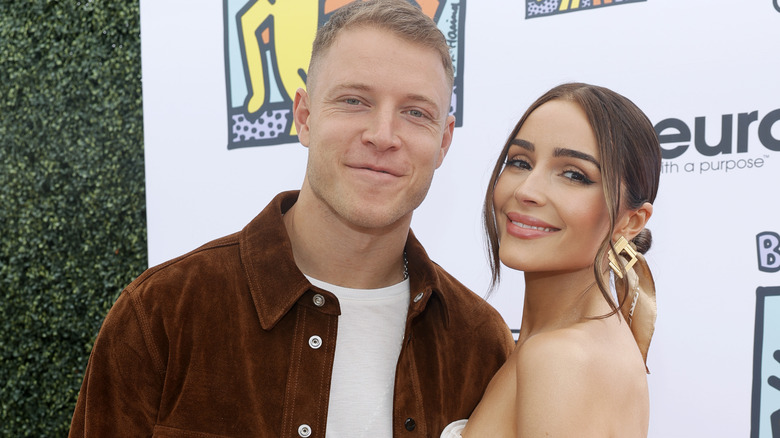 Christian McCaffrey and Olivia Culpo posing