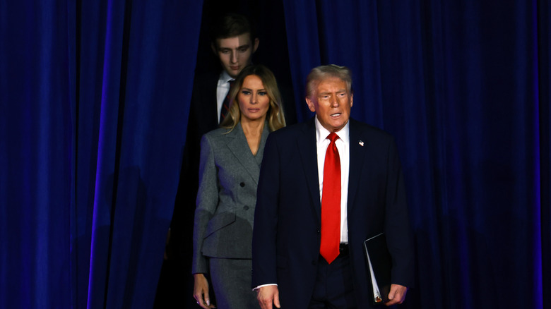 Barron Trump, Melania, and Donald Trump walking on stage