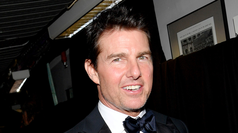 Tom Cruise smiling wearing a bow tie tuxedo