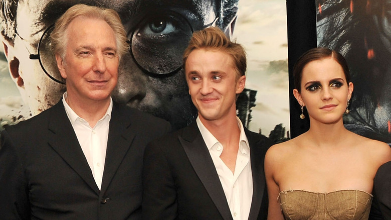 Alan Rickman, Tom Felton, and Emma Watson pose together