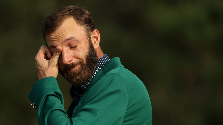 Dustin Johnson wipes a tear