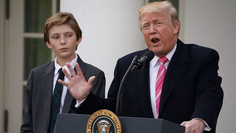 Barron Trump and Donald Trump at a podium