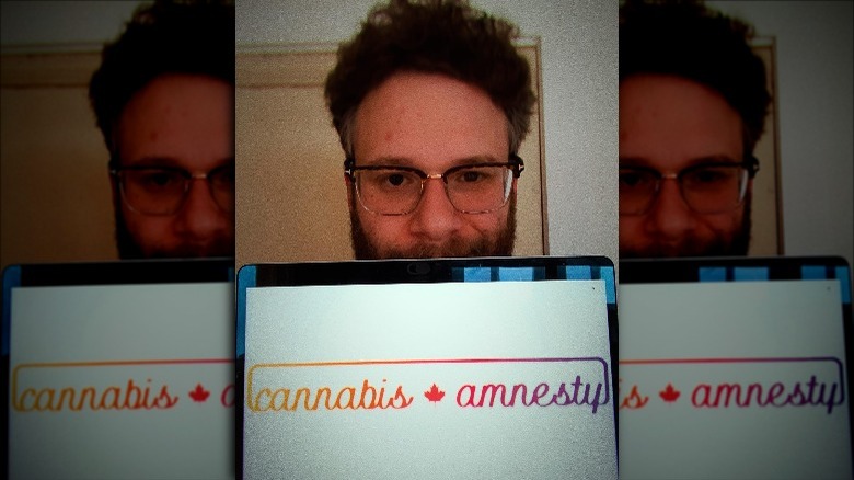 Seth Rogen in front of computer screen that reads 'Cannabis Amnesty.'