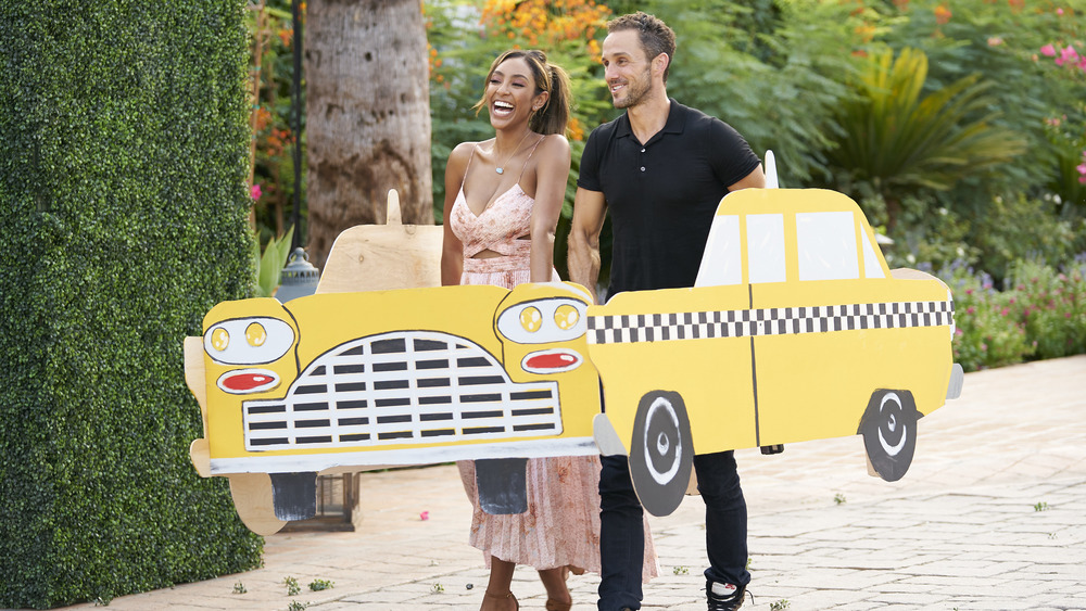 Tayshia Adams and Zac Clark driving through a set of New York City