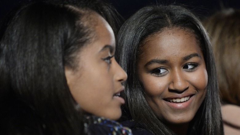 Sasha Obama looking at her sister Malia