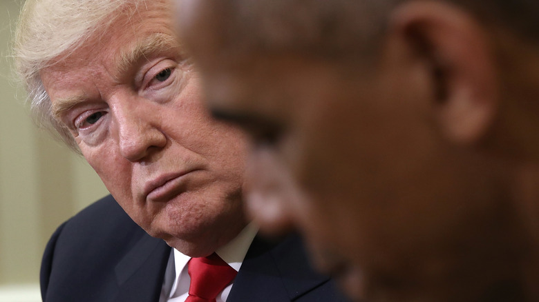 Donald Trump staring at Barack Obama