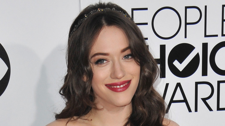 Kat Dennings wearing red lipstick on red carpet