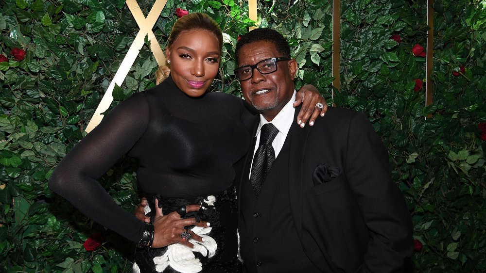 Nene Leakes and Greg Leakes arm in arm, posing