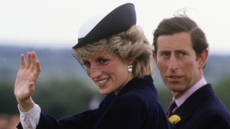 Princess Diana and King Charles waving to the crowd.