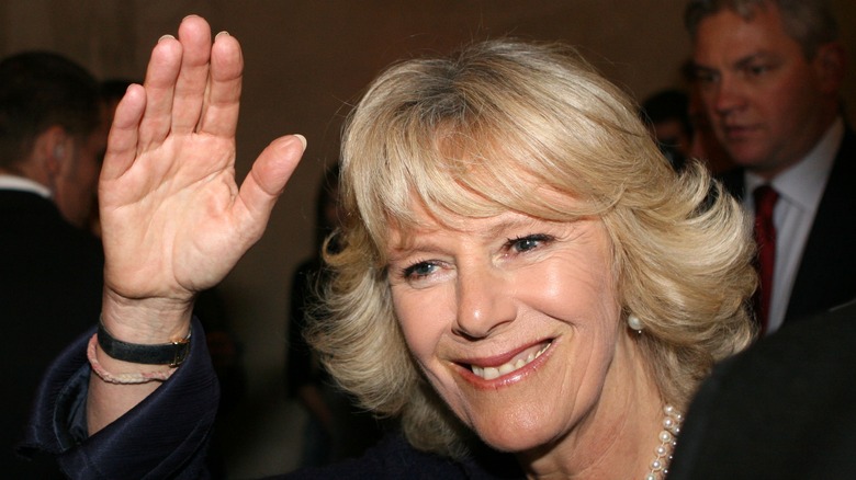 Camilla Parker Bowles smiling and waving.