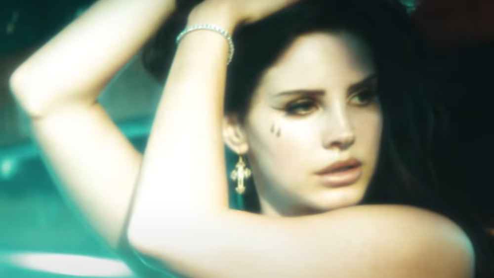 Lana Del Rey with teardrop tattoos in her Tropico short film 