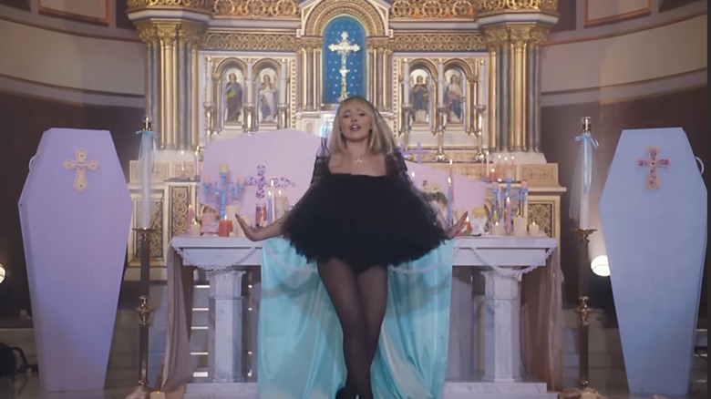 Sabrina Carpenter wearing black at an altar