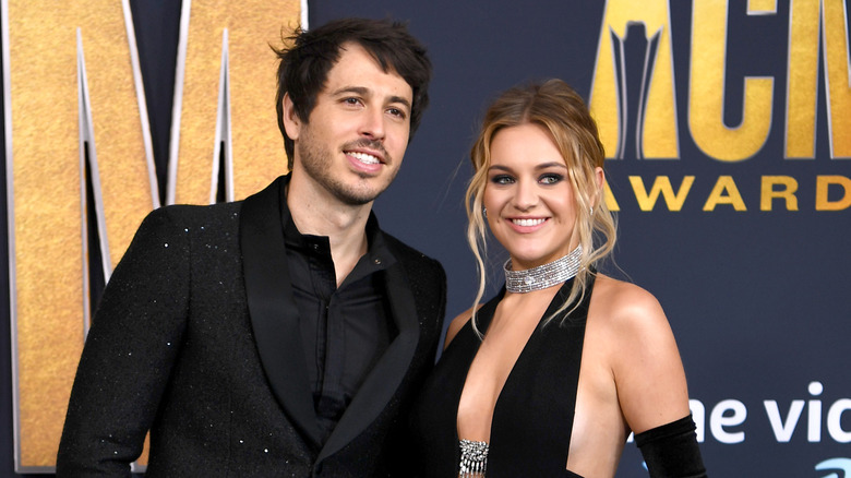 Kelsea Ballerini and Morgan Evans pose at the CMA Awards