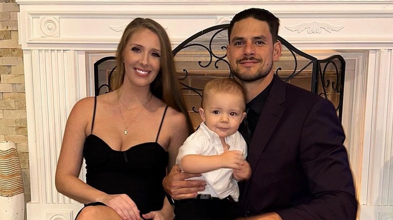 Jenna Compono and Zach Nichols pose with son