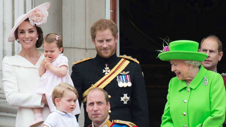 Prince William crouches by Prince George