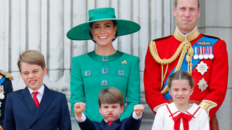 Prince Louis posing with family, fists in air