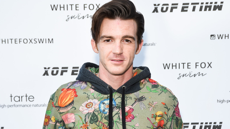 Drake Bell in floral hooded top