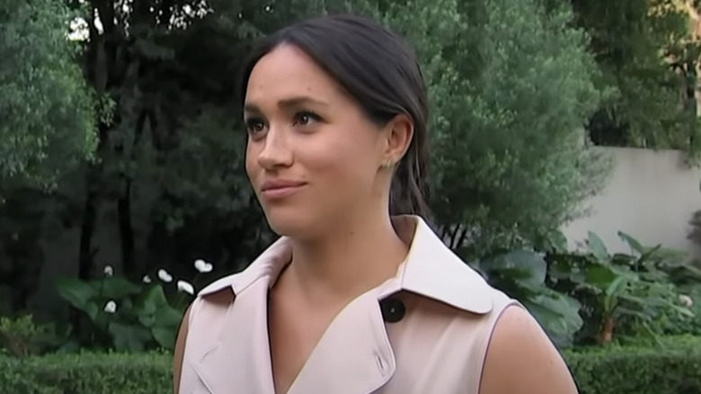 Meghan Markle standing in garden