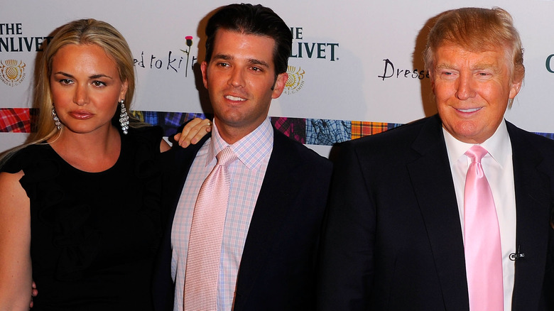 Donald Trump Jr. standing between his ex-wife and farther