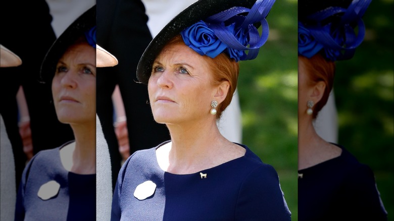 Sarah Ferguson looking to the sky, wearing a blue hat