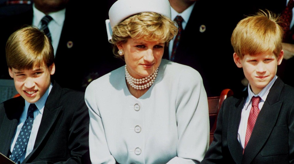 Prince William, Princess Diana, and prince Harry attending an outdoor event 